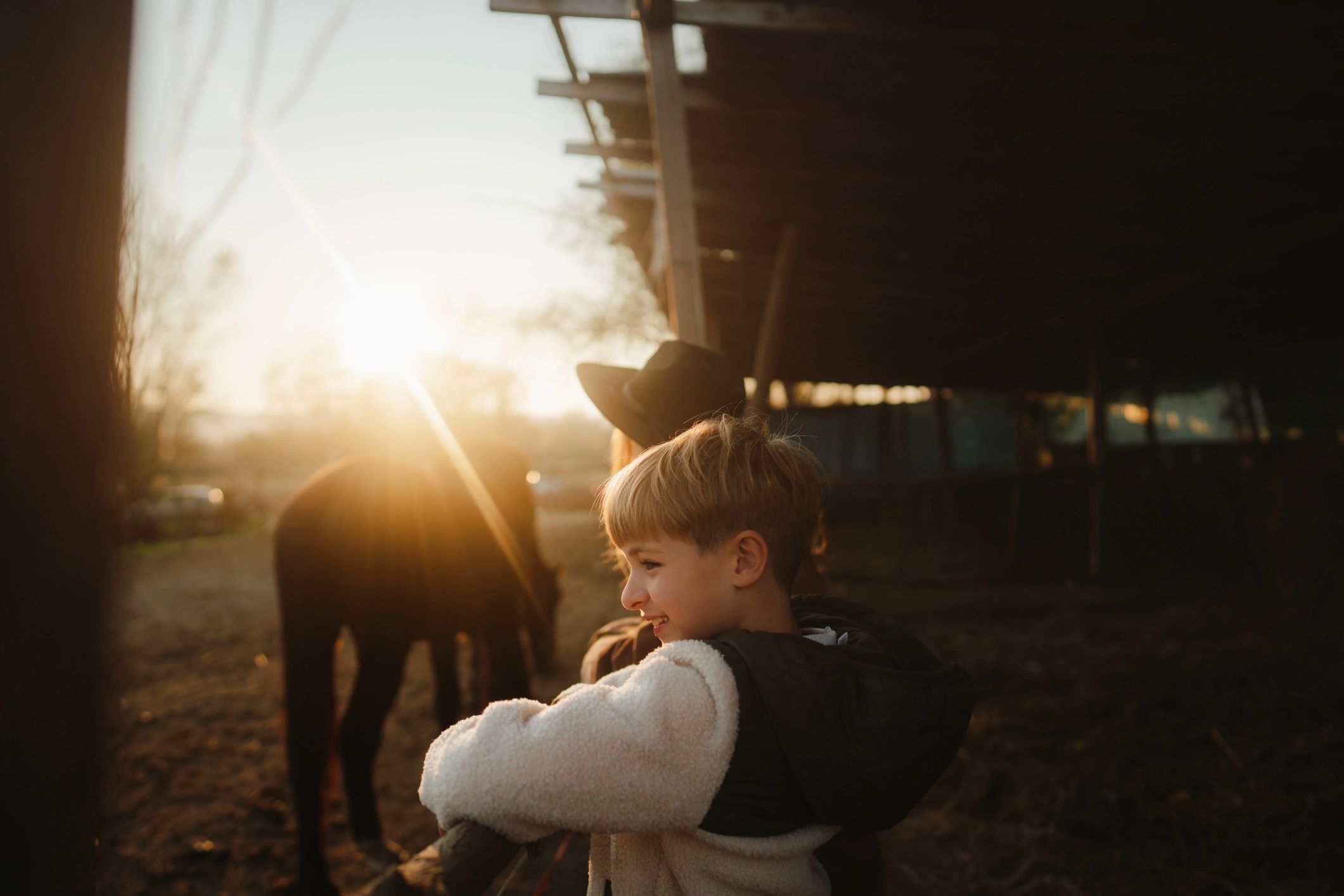 Parent and child with a horse at a farm